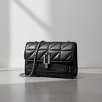 www.bhplus.shop black quilted faux leather crossbody bag with silver chain strap and clasp closure.