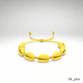 www.bhplus.shop yellow cowrie shell bracelet with gold bead accents and adjustable cord.